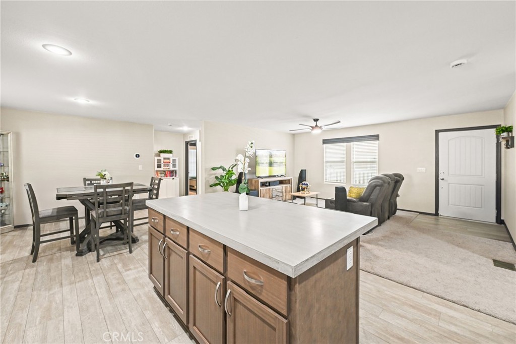 16860 Slover Avenue, Unit 70 Fontana, CA 92337 - Photo 10 of 38 a large kitchen with kitchen island a sink table and chairs