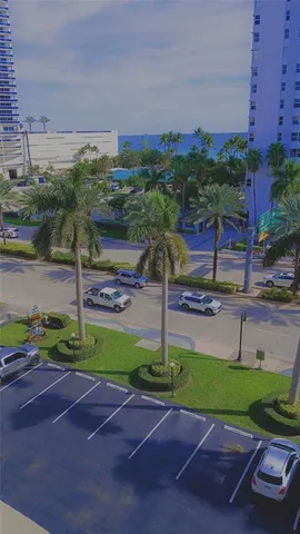 a view of a street with a building and a street sign