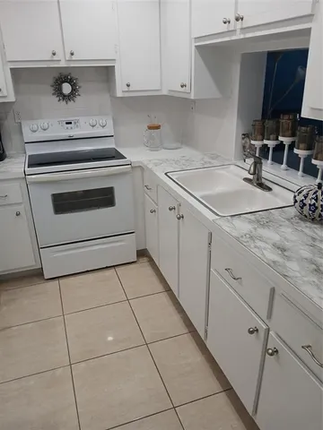 a kitchen with a stove a sink and a microwave