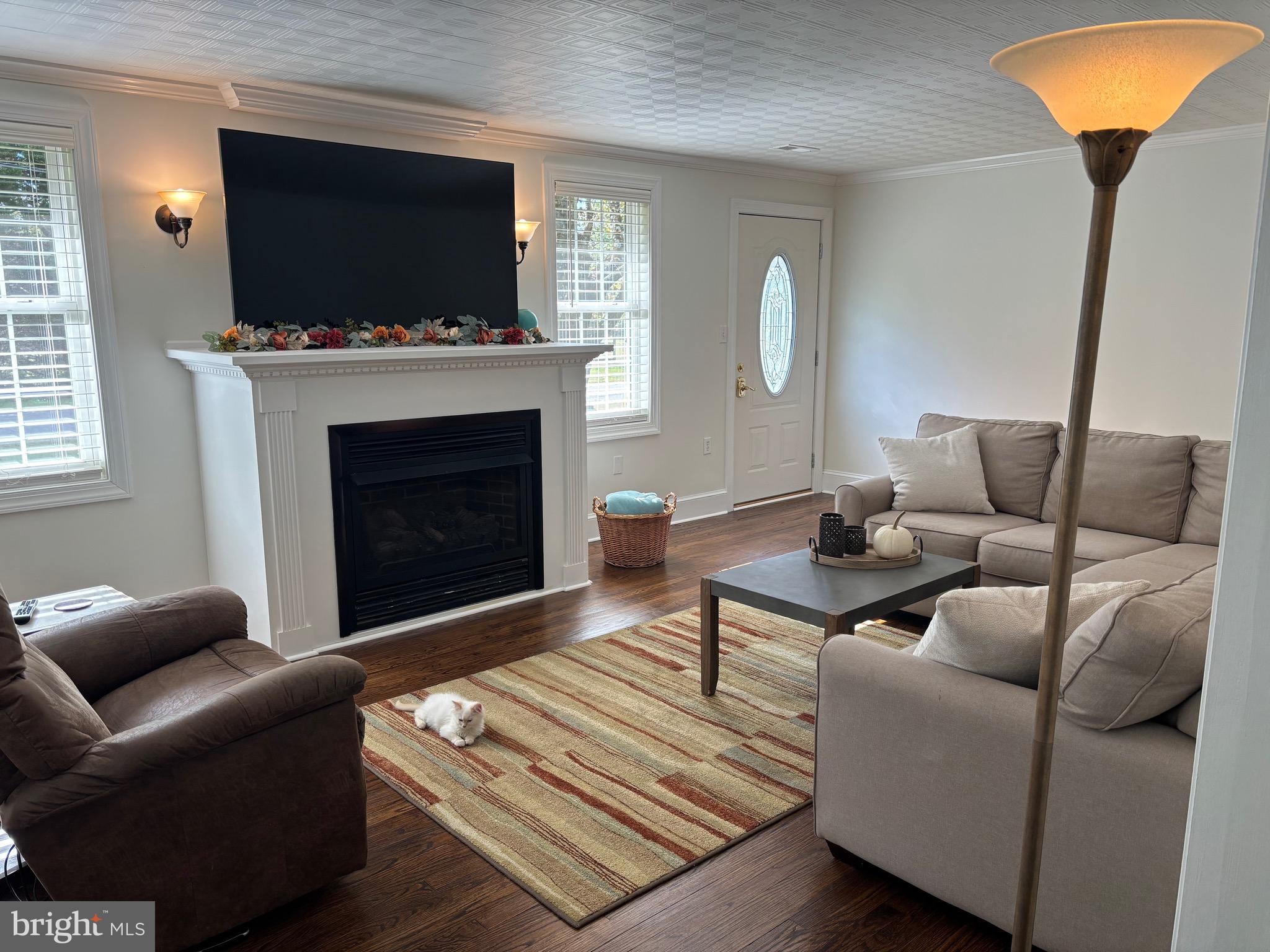 355-m F M F Bowen Road Huntingtown, MD 20639 - Photo 12 of 47 a living room with furniture a flat screen tv and a fireplace