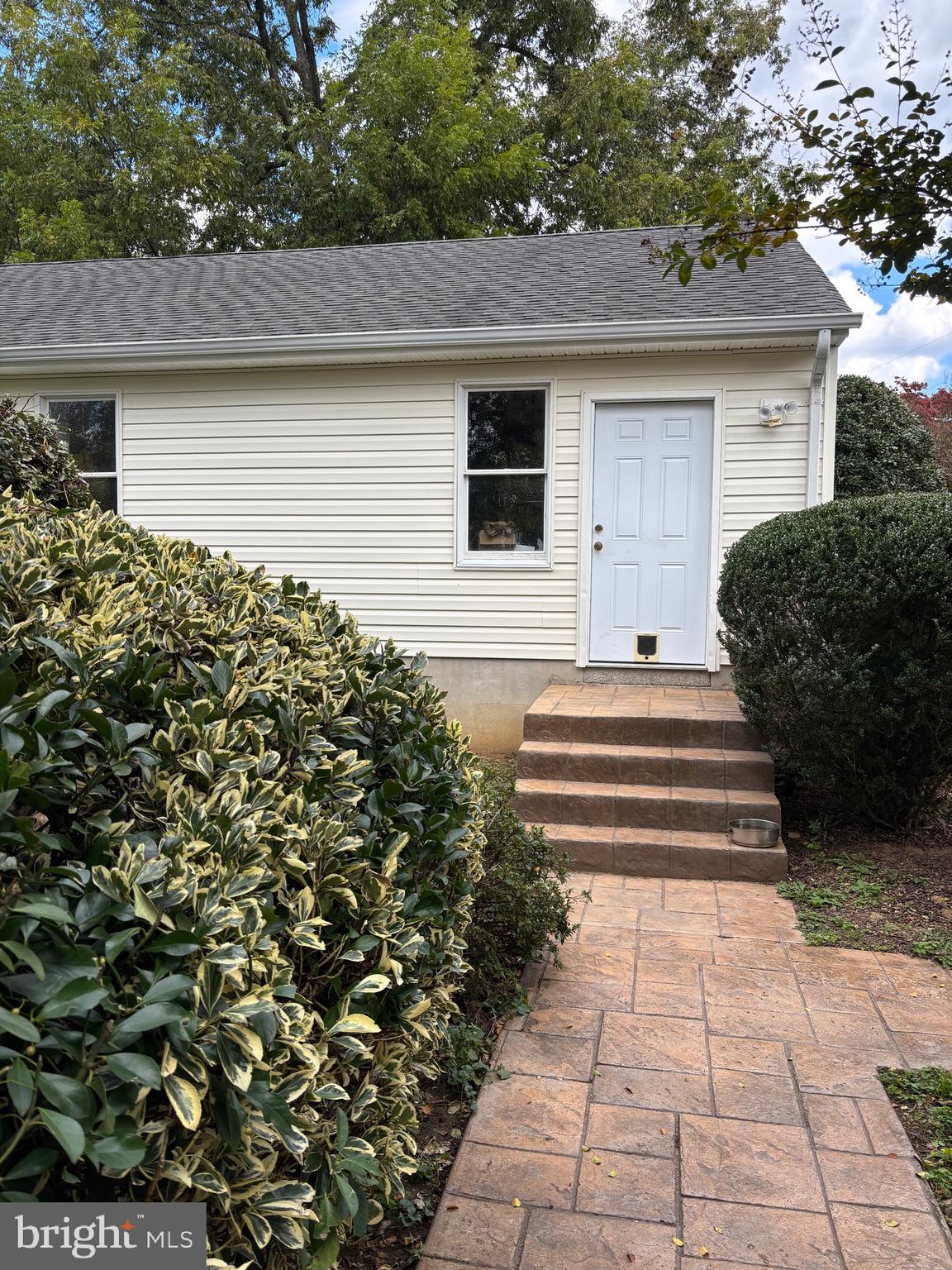 355-m F M F Bowen Road Huntingtown, MD 20639 - Photo 4 of 47 a front view of a house with a garden