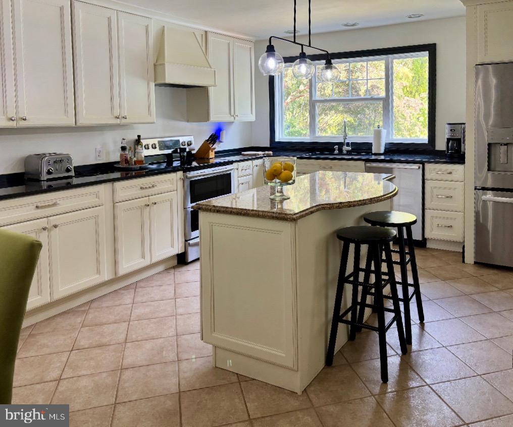 355-m F M F Bowen Road Huntingtown, MD 20639 - Photo 7 of 47 a kitchen with a sink a counter top space cabinets and stainless steel appliances