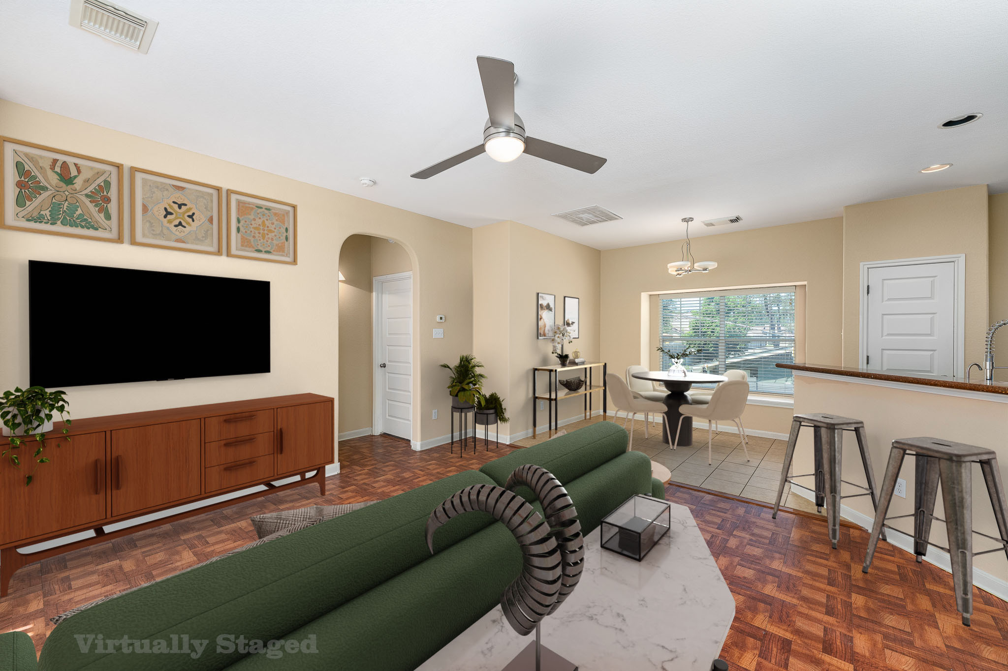 2829 Saville Loop, Unit 17C Austin, TX 78741 - Photo 4 of 28 Warm wood flooring extends throughout this inviting, open-concept living space with a dining area and kitchen pass-through.