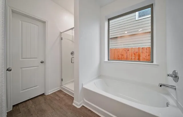 a white bath tub sitting next to a window
