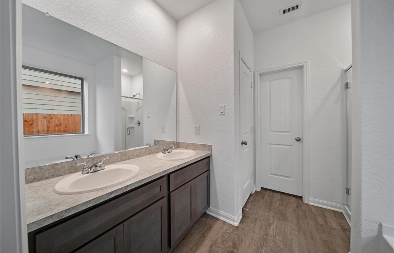 14224 Grand Hills Drive Conroe, TX 77303 - Photo 15 of 17 a bathroom with a granite countertop sink a mirror and a
