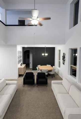 a living room with furniture and a chandelier