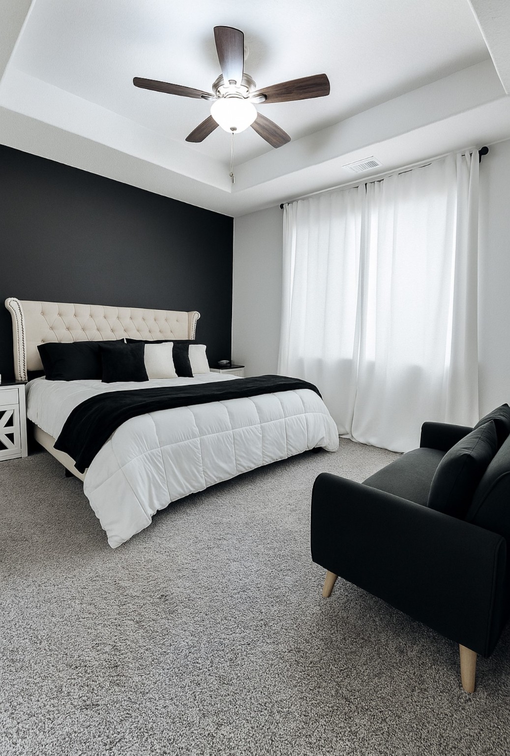 14224 Grand Hills Drive Conroe, TX 77303 - Photo 5 of 17 a bedroom with a bed couch chandelier and a window