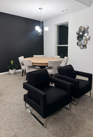 a living room with furniture a chandelier and a rug