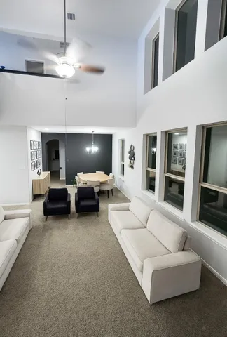 a living room with furniture and a chandelier