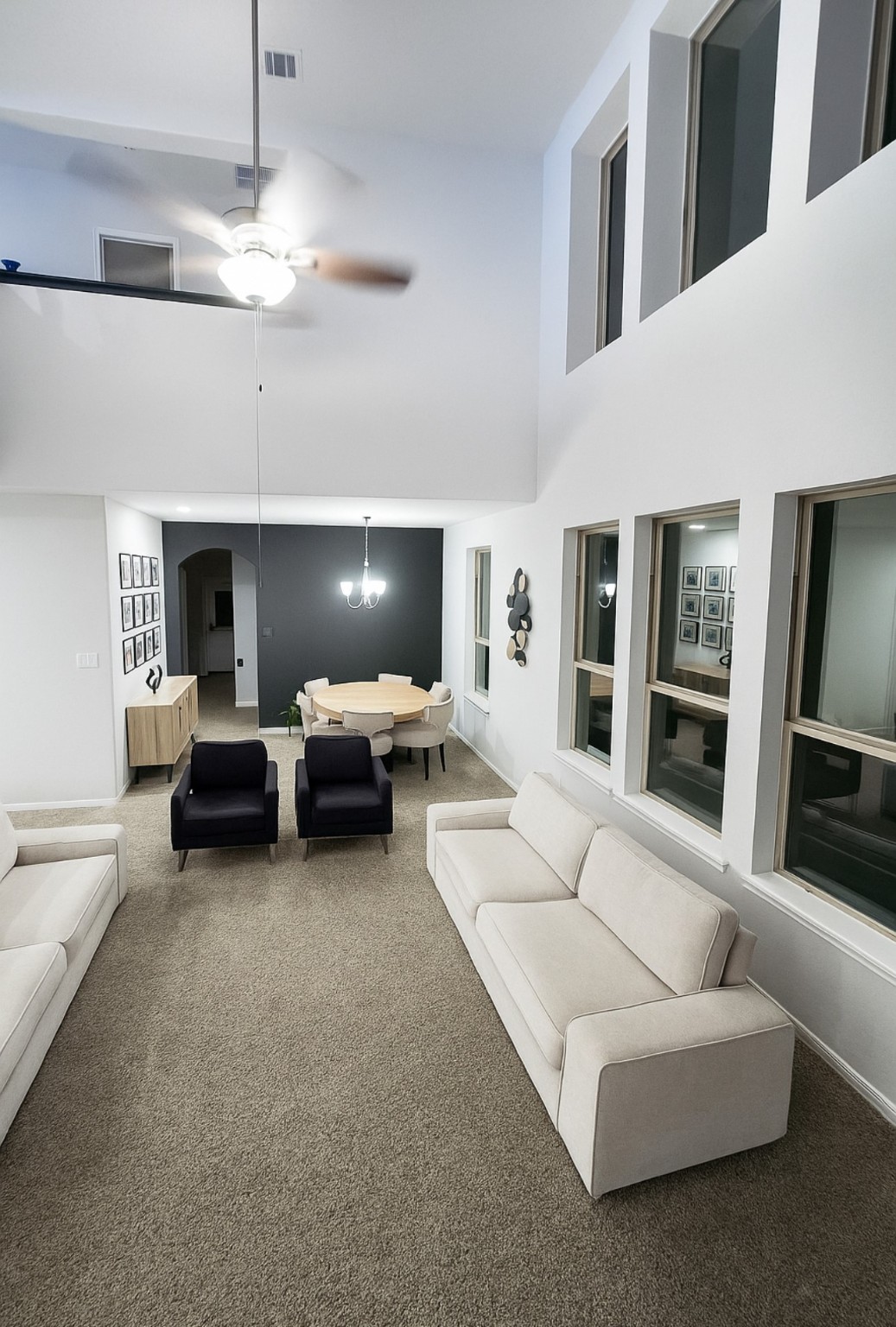 14224 Grand Hills Drive Conroe, TX 77303 - Photo 8 of 17 a living room with furniture and a chandelier