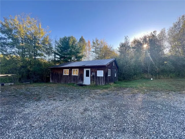 a view of a small house with a yard