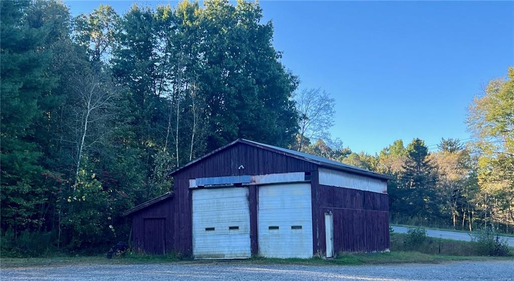 523 Farren Surrena Road Harrisville, PA 16038 - Photo 3 of 24 a view of a barn in a big yard with large trees