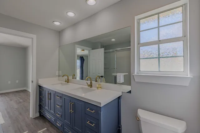 a bathroom with a toilet sink and mirror