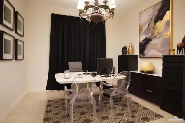 a bedroom with two beds and a chandelier