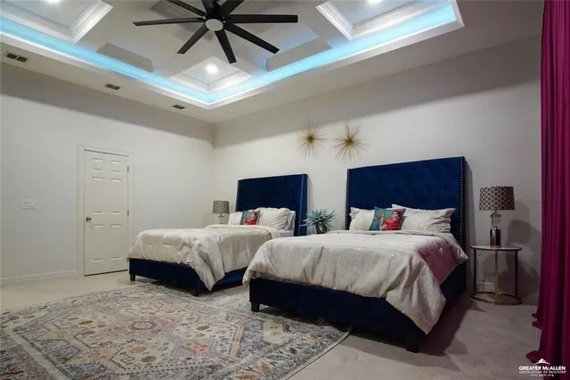 a bedroom with two beds and a potted plant