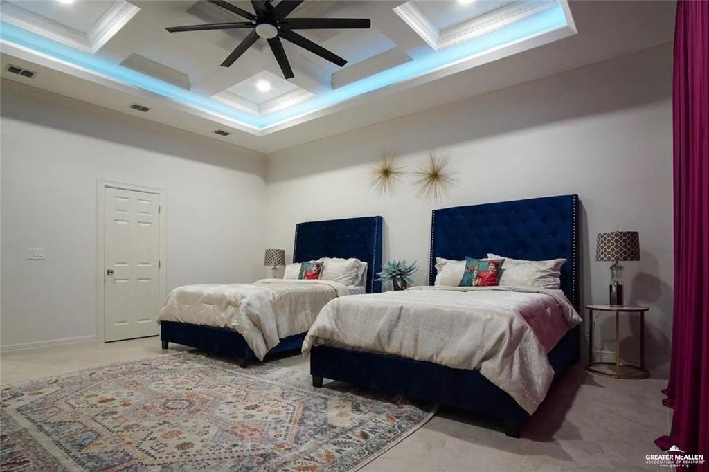 1413 Encantado Circle Palmview, TX 78572 - Photo 15 of 25 a bedroom with two beds and a chandelier