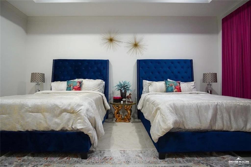 1413 Encantado Circle Palmview, TX 78572 - Photo 16 of 25 a bedroom with two beds and a potted plant