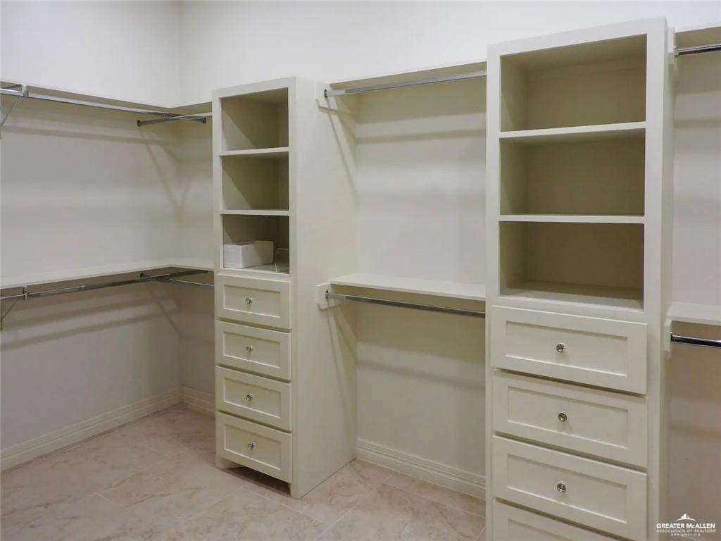 1413 Encantado Circle Palmview, TX 78572 - Photo 22 of 25 a view of walk in closet with empty racks