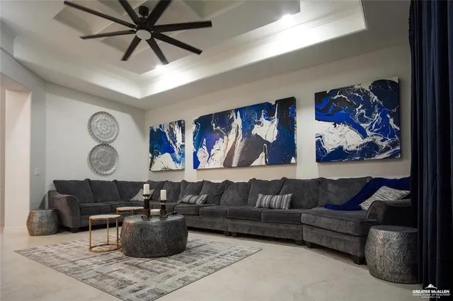 a living room with furniture and wall paintings