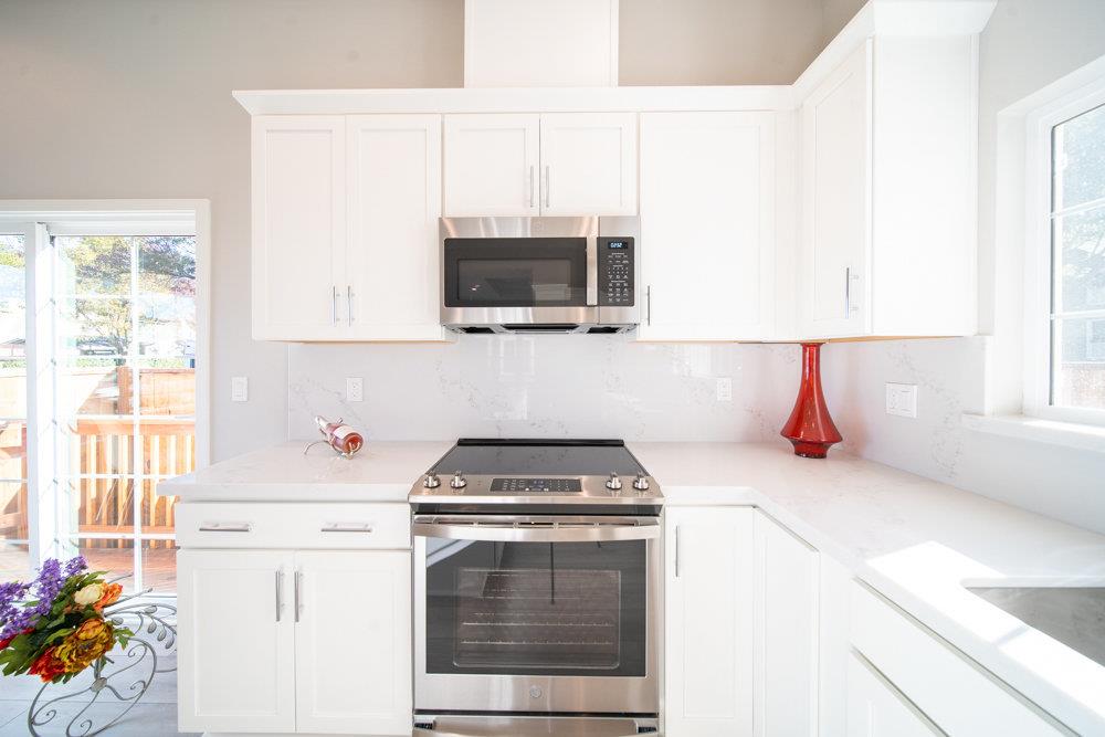1701 Ringwood Avenue San Jose, CA 95131 - Photo 12 of 59 a kitchen with granite countertop a stove a sink and a microwave