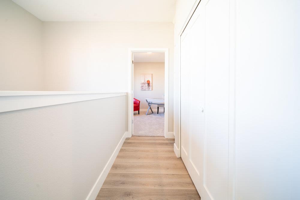 1701 Ringwood Avenue San Jose, CA 95131 - Photo 23 of 59 a view of a hallway with wooden floor and a bathroom