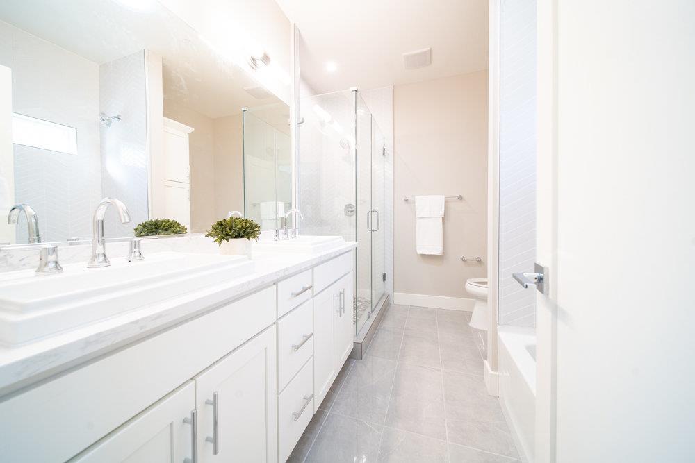 1701 Ringwood Avenue San Jose, CA 95131 - Photo 28 of 59 a spacious bathroom with a double vanity sink and mirror