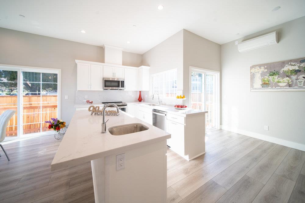 1701 Ringwood Avenue San Jose, CA 95131 - Photo 9 of 59 a kitchen with a sink a counter top space and living room area