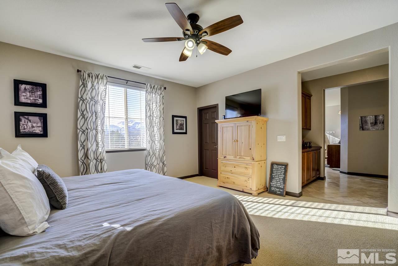 460 Ruffian Court Reno, NV 89521 - Photo 14 of 25 a bedroom with a bed and a flat screen tv