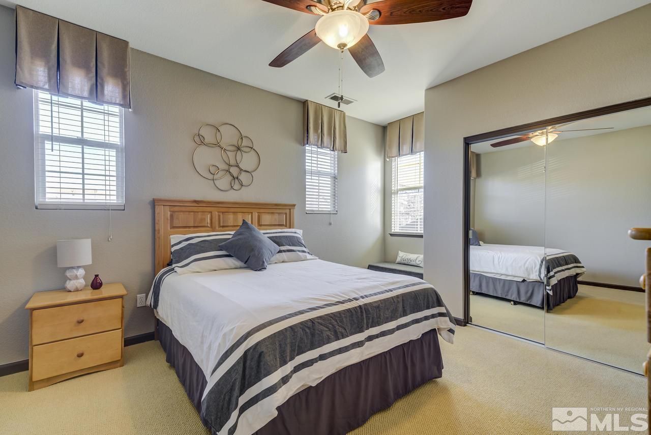 460 Ruffian Court Reno, NV 89521 - Photo 16 of 25 a bedroom with a bed and a chandelier