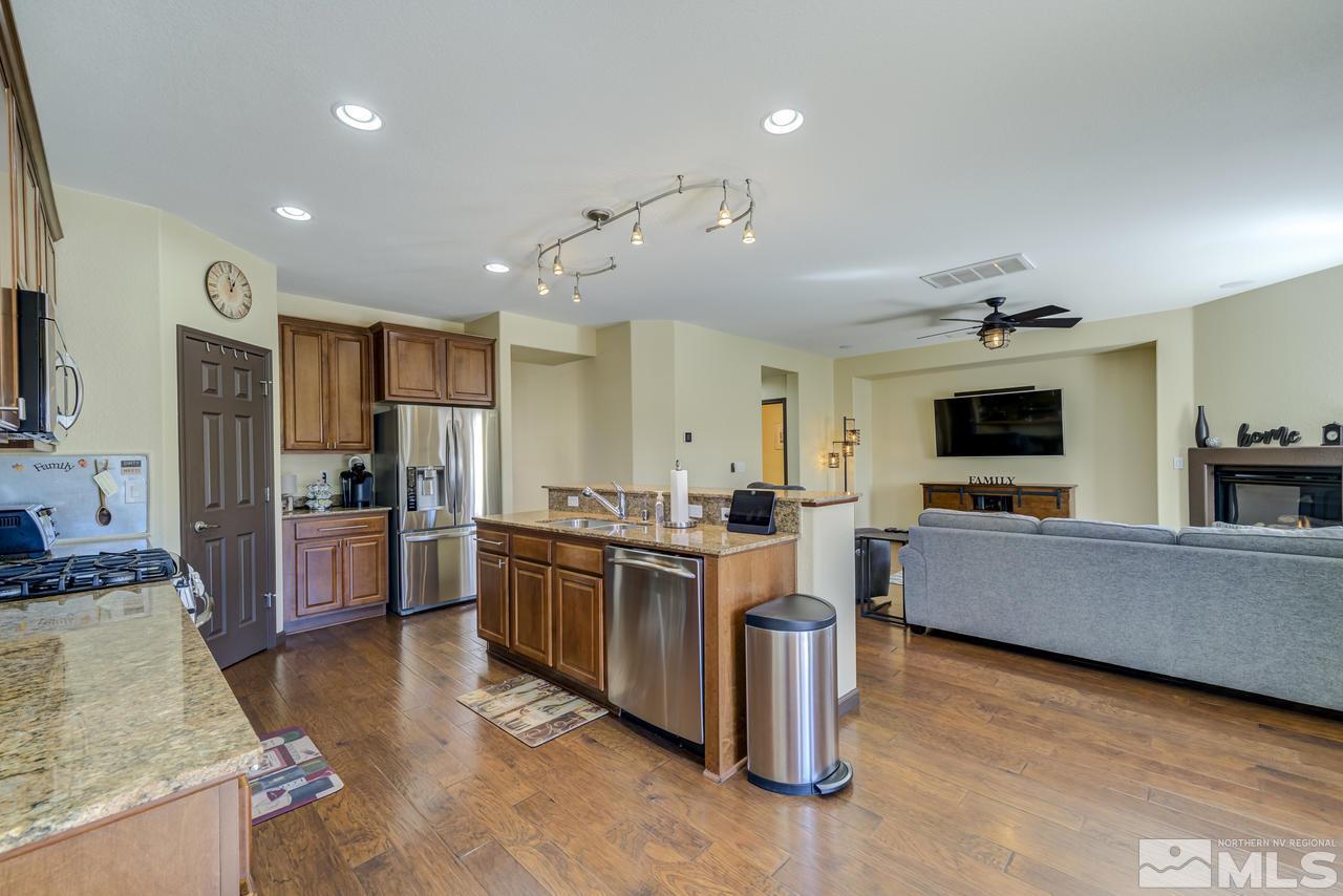 460 Ruffian Court Reno, NV 89521 - Photo 10 of 25 a large living room with stainless steel appliances granite countertop a couch and a view of living room