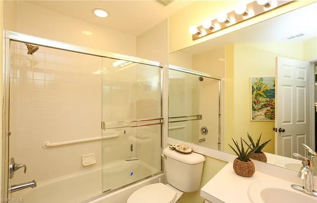 a bathroom with a shower a sink and a mirror