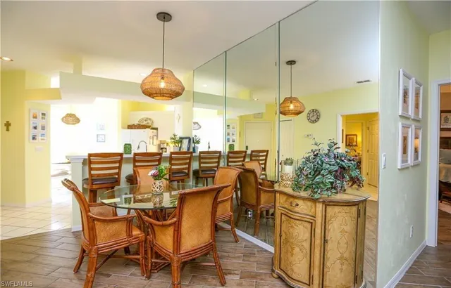 a dining room filled with furniture and wooden floor