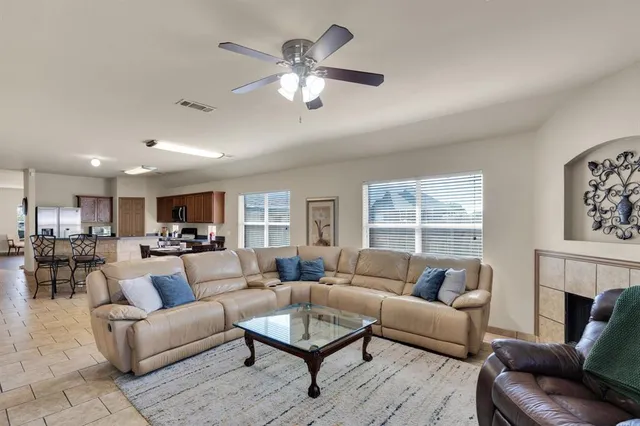 a kitchen with stainless steel appliances a sink a stove a refrigerator cabinets and dining table