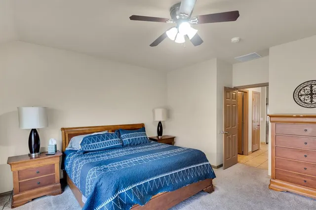 a living room with furniture a fireplace and a large window