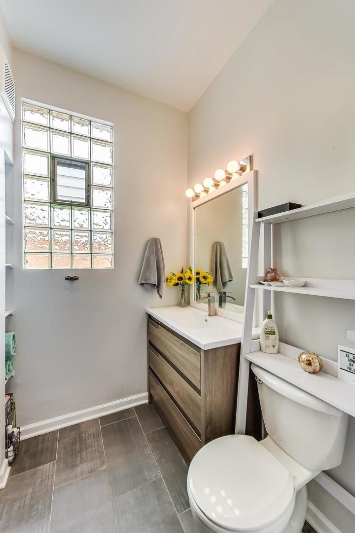 2145 West Thomas Street, Unit 3 Chicago, IL 60622 - Photo 13 of 17 a bathroom with a granite countertop toilet sink and mirror