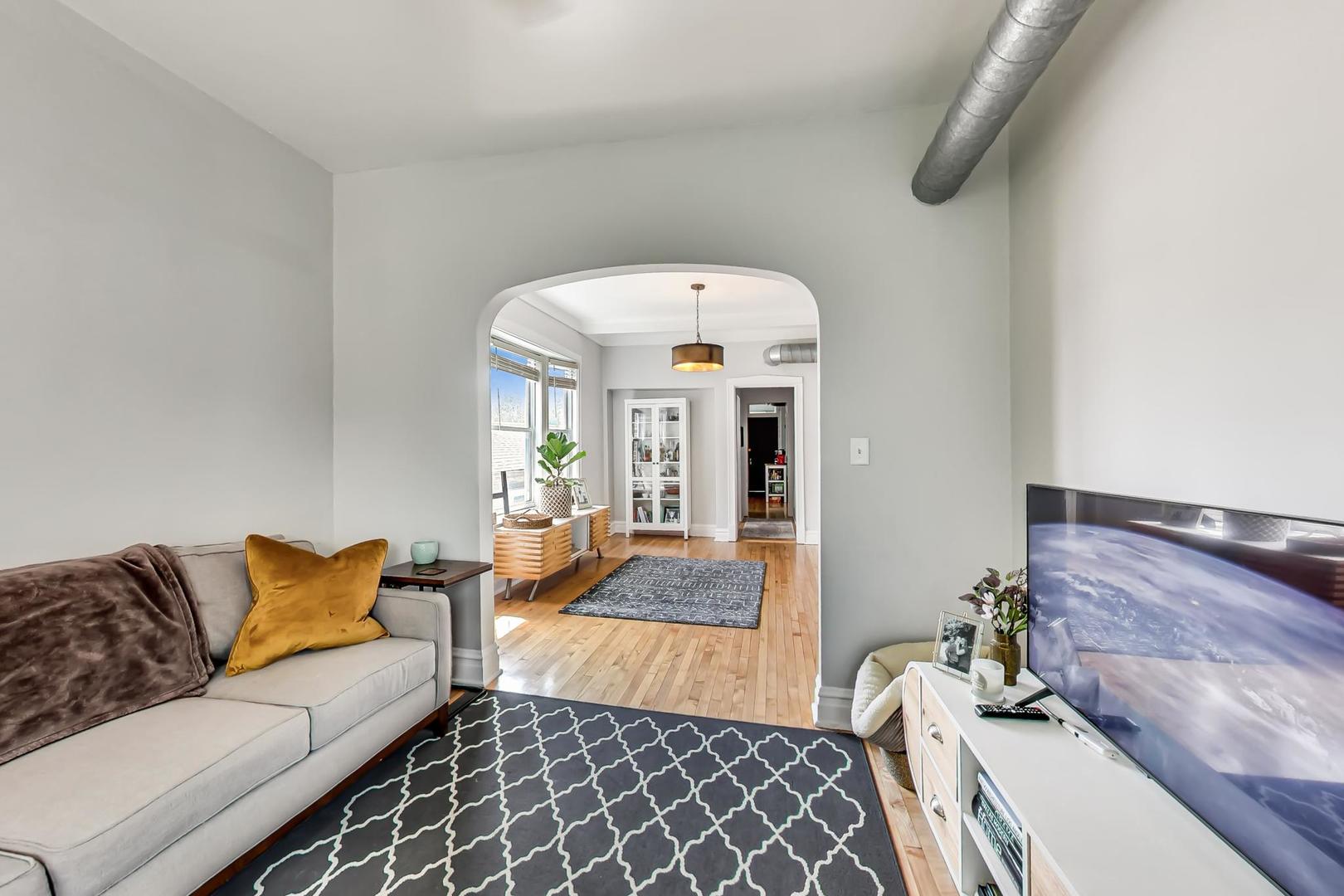 2145 West Thomas Street, Unit 3 Chicago, IL 60622 - Photo 2 of 17 a living room with furniture and a rug