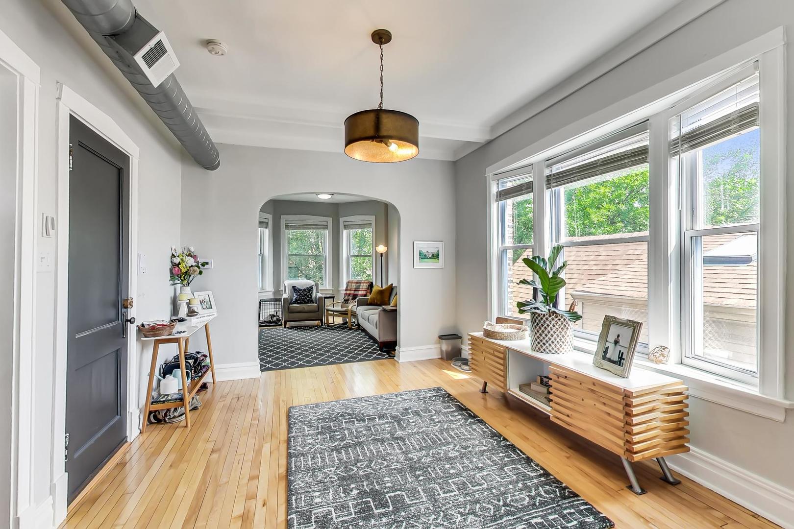 2145 West Thomas Street, Unit 3 Chicago, IL 60622 - Photo 5 of 17 a living room with furniture fireplace and a large window