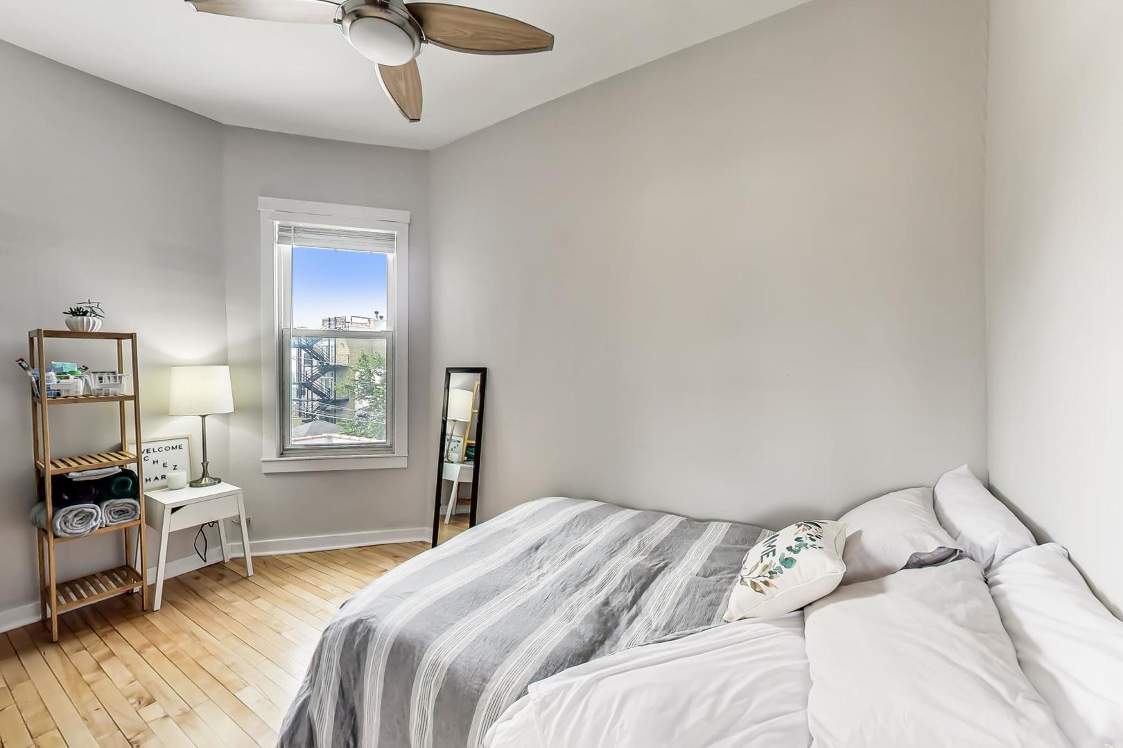 2145 West Thomas Street, Unit 3 Chicago, IL 60622 - Photo 9 of 17 a bedroom with a bed and a chair