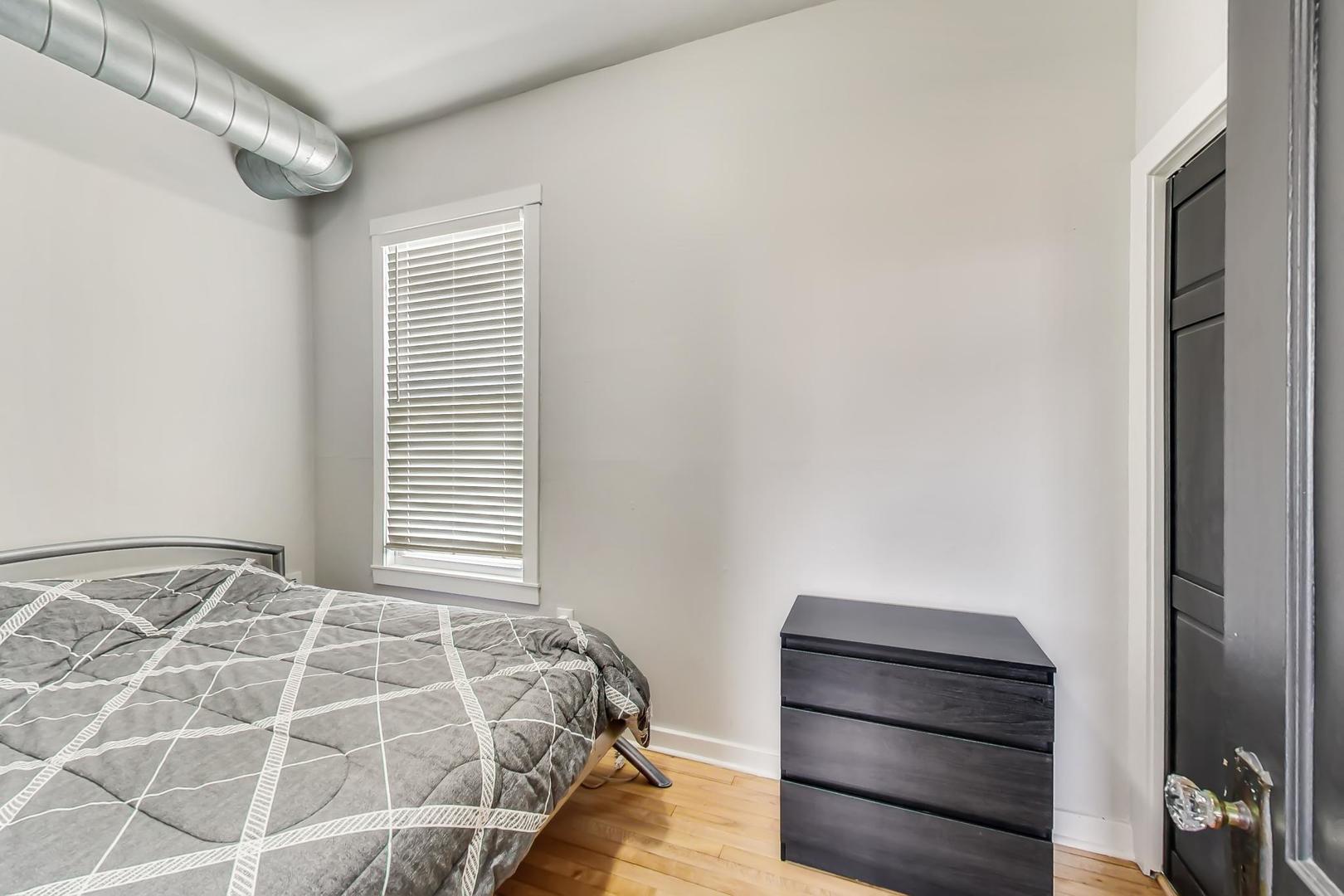 2145 West Thomas Street, Unit 3 Chicago, IL 60622 - Photo 10 of 17 a bedroom with a bed and a window