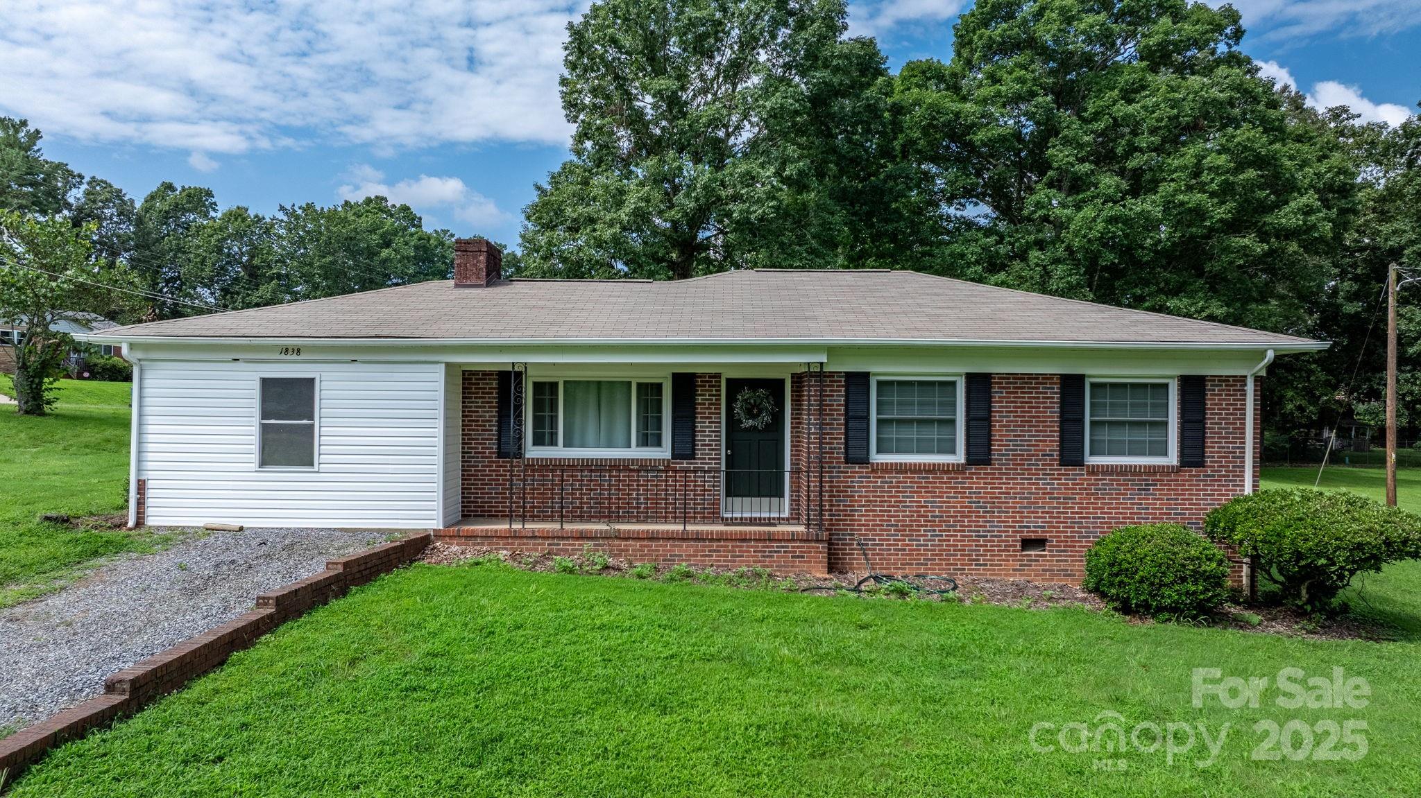 a aerial view of a house next to a yard