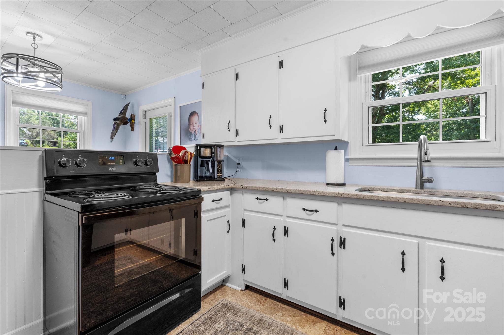 1838 Connelly Springs Road Lenoir, NC 28645 - Photo 11 of 24 a kitchen with granite countertop a stove sink and cabinets