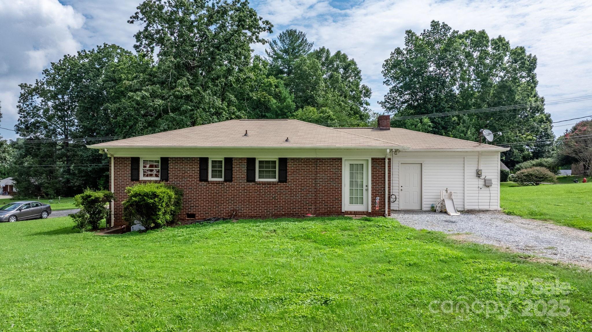 1838 Connelly Springs Road Lenoir, NC 28645 - Photo 20 of 24 a front view of a house with a garden and porch