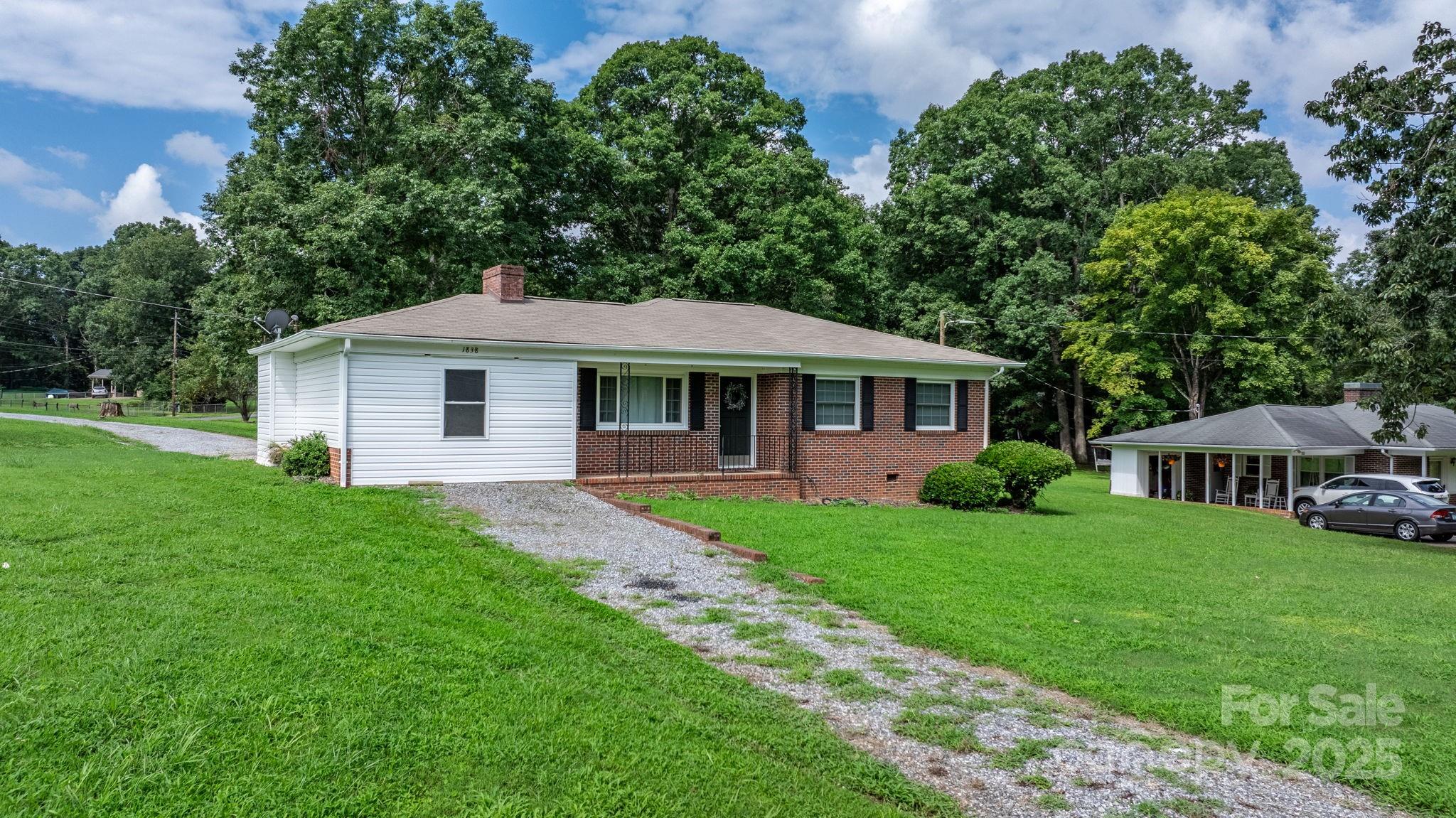 1838 Connelly Springs Road Lenoir, NC 28645 - Photo 2 of 24 a front view of a house with garden