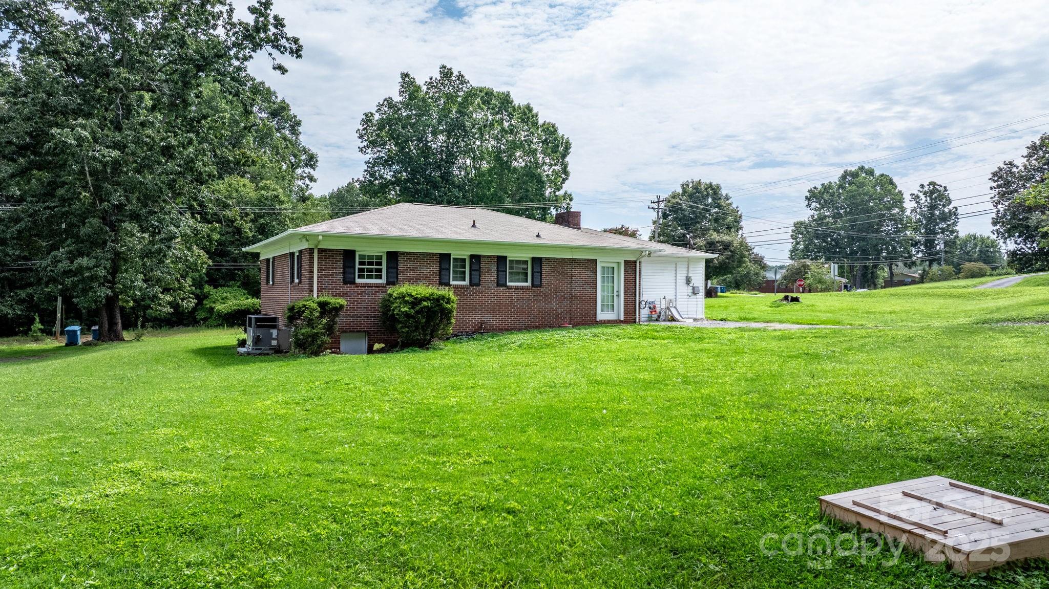 1838 Connelly Springs Road Lenoir, NC 28645 - Photo 22 of 24 a view of a house with a backyard