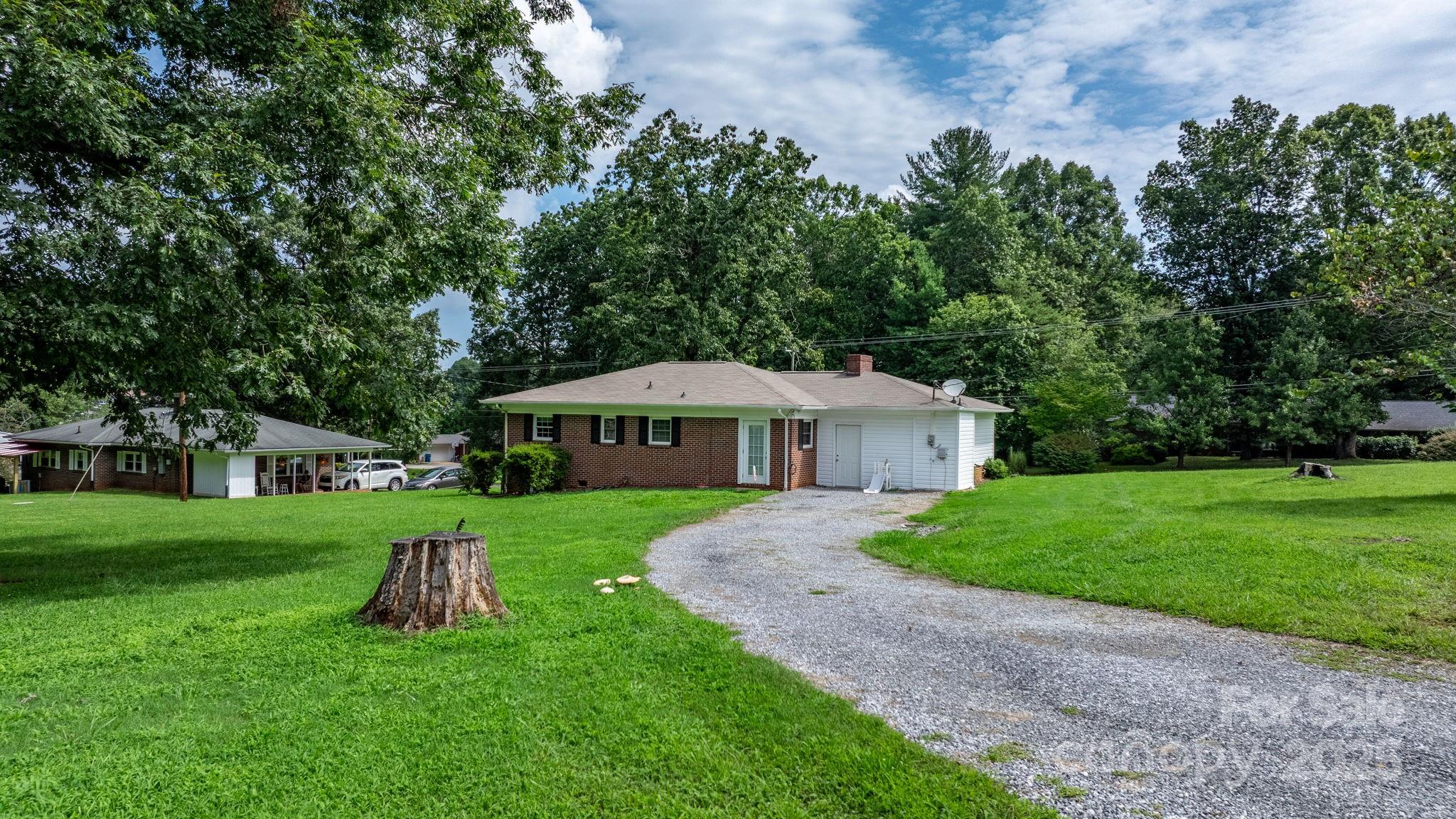1838 Connelly Springs Road Lenoir, NC 28645 - Photo 23 of 24 a view of a house with a big yard potted plants and large tree