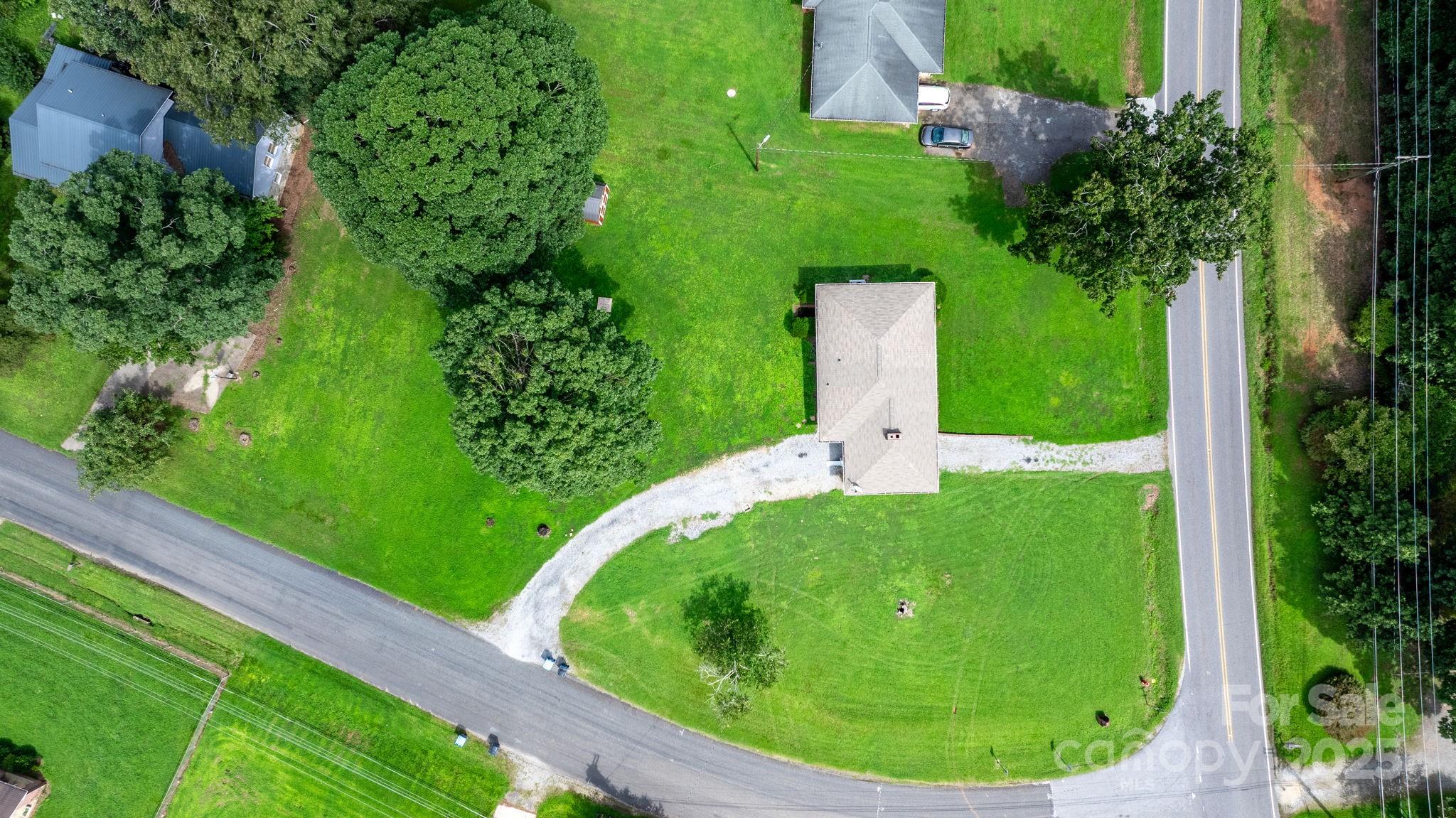 1838 Connelly Springs Road Lenoir, NC 28645 - Photo 4 of 24 a view of a garden with a house