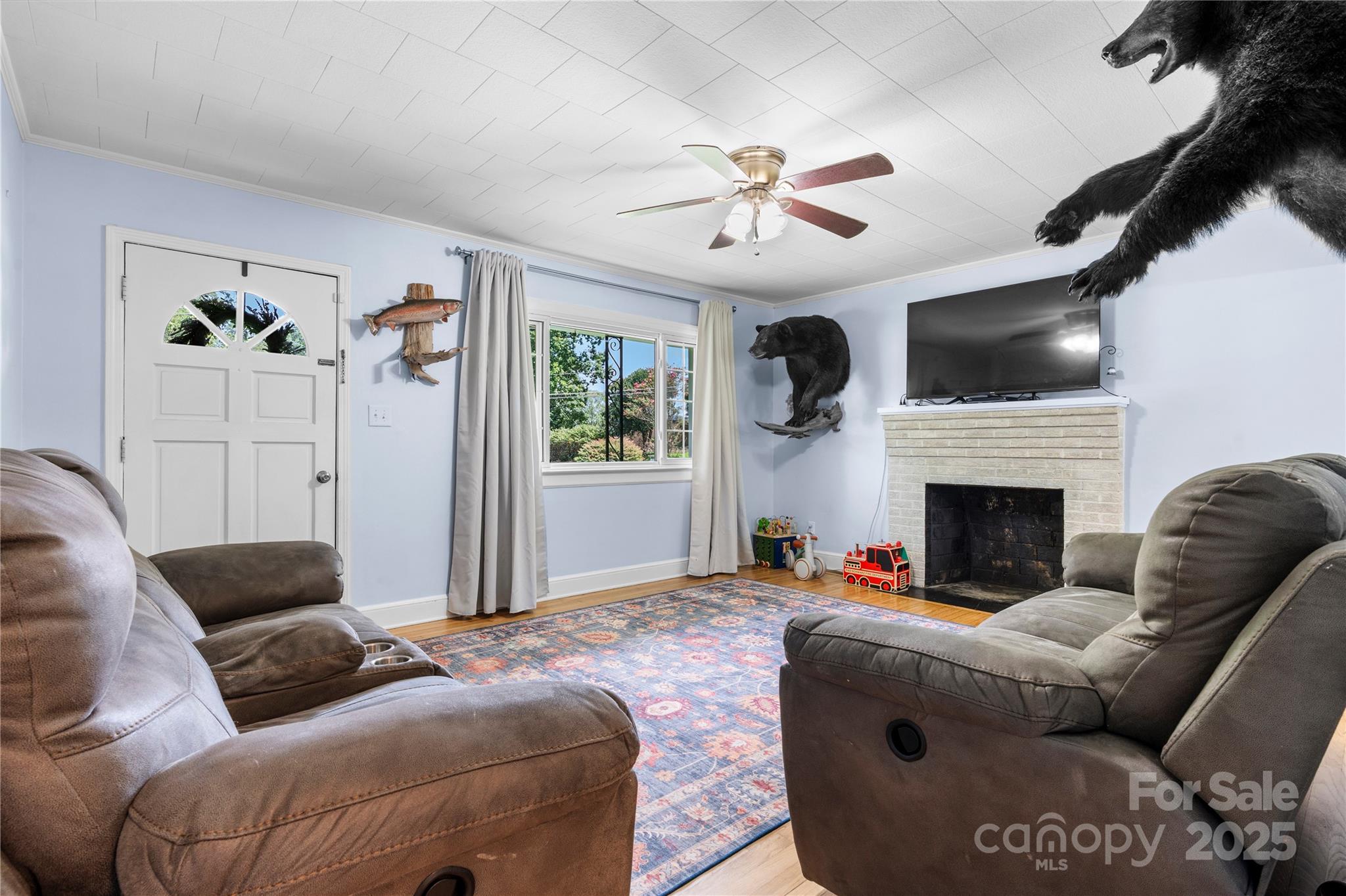 1838 Connelly Springs Road Lenoir, NC 28645 - Photo 7 of 24 a living room with furniture a flat screen tv and a fireplace