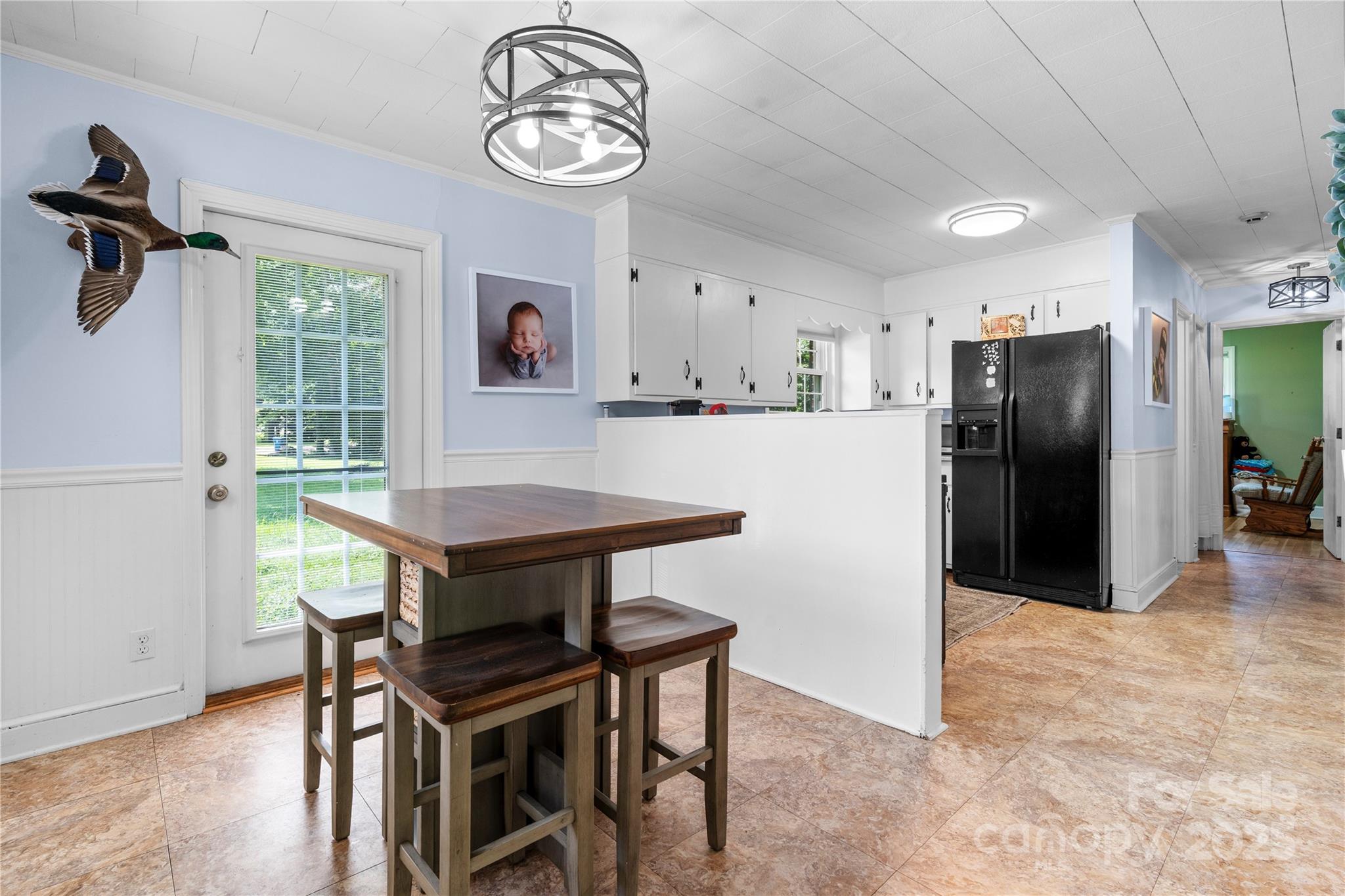 1838 Connelly Springs Road Lenoir, NC 28645 - Photo 8 of 24 a kitchen with a table and a refrigerator