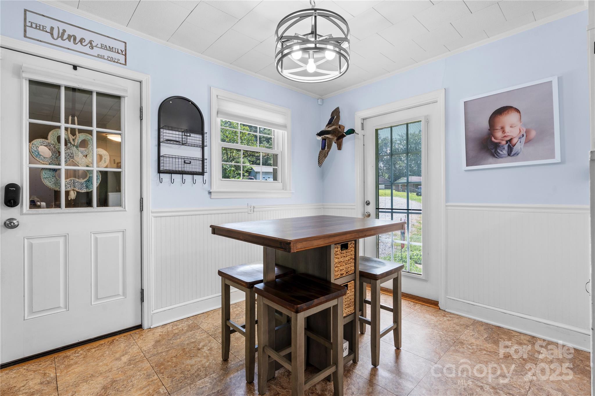 1838 Connelly Springs Road Lenoir, NC 28645 - Photo 9 of 24 a view of a dining room with furniture window and wooden floor