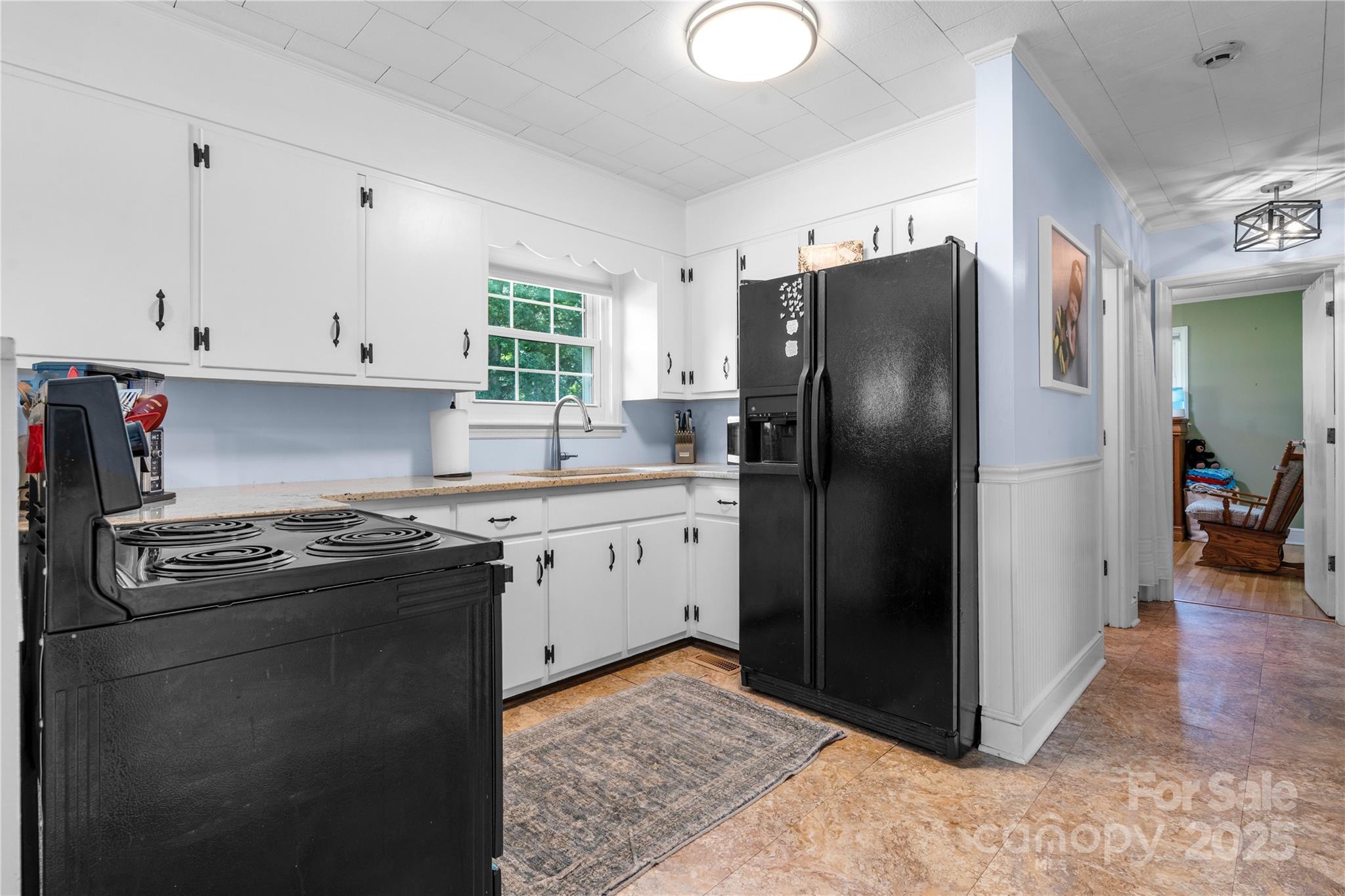 1838 Connelly Springs Road Lenoir, NC 28645 - Photo 10 of 24 a kitchen with a stove refrigerator and cabinets